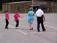 Officer Gerald Smith with dance students warming-up before presentation.